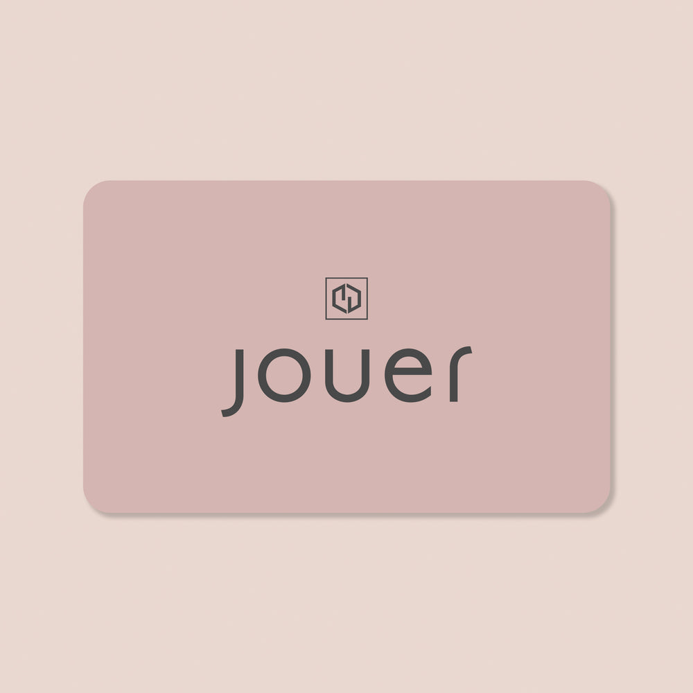 A gift card from Jouer Cosmetics featuring a pink rectangle with rounded corners. The word "jouer" is printed in lowercase black letters at the center, and above it is a small, black geometric logo made of interlocking shapes. The background is light beige.