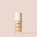 Nude face serum bottle labeled Jouer Luminizing Glow Serum with niacinamide, vitamin C, and hyaluronic acid on neutral background.