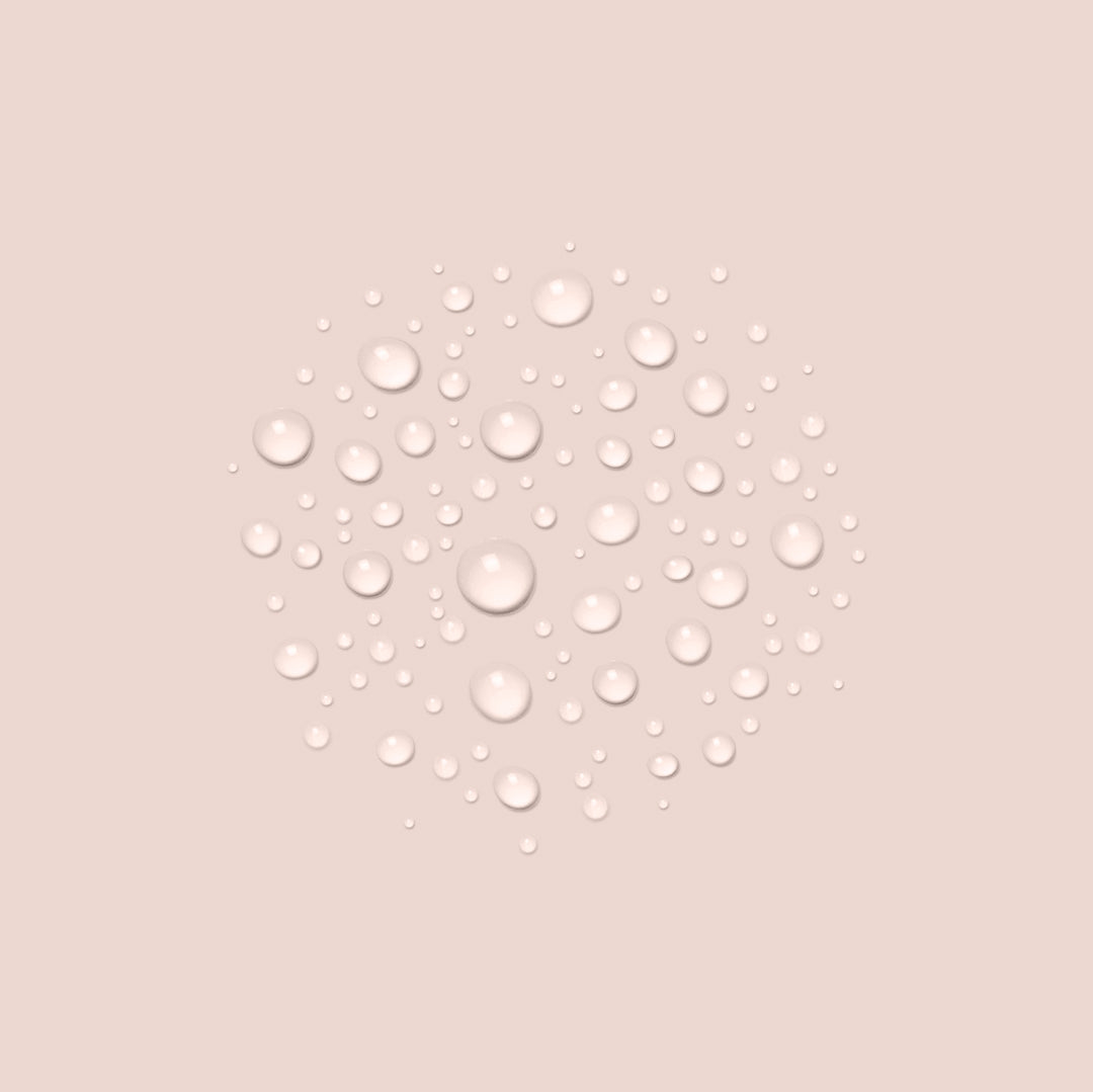 100ml, A cluster of various-sized water droplets is arranged in a circular pattern against a beige background. The droplets are clear and reflect light, giving a glossy appearance, reminiscent of the purity found in Jouer Cosmetics' Moisture Mist.