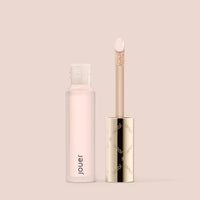 Jouer Essential liquid concealer tube with applicator wand open on pink background