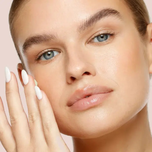 Skin barrier balm being applied to glowing skin for intense hydration and protection.