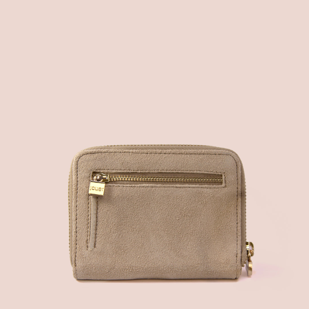 Petite Pochette compact suede travel case with gold zipper detailing and exterior zip pocket.