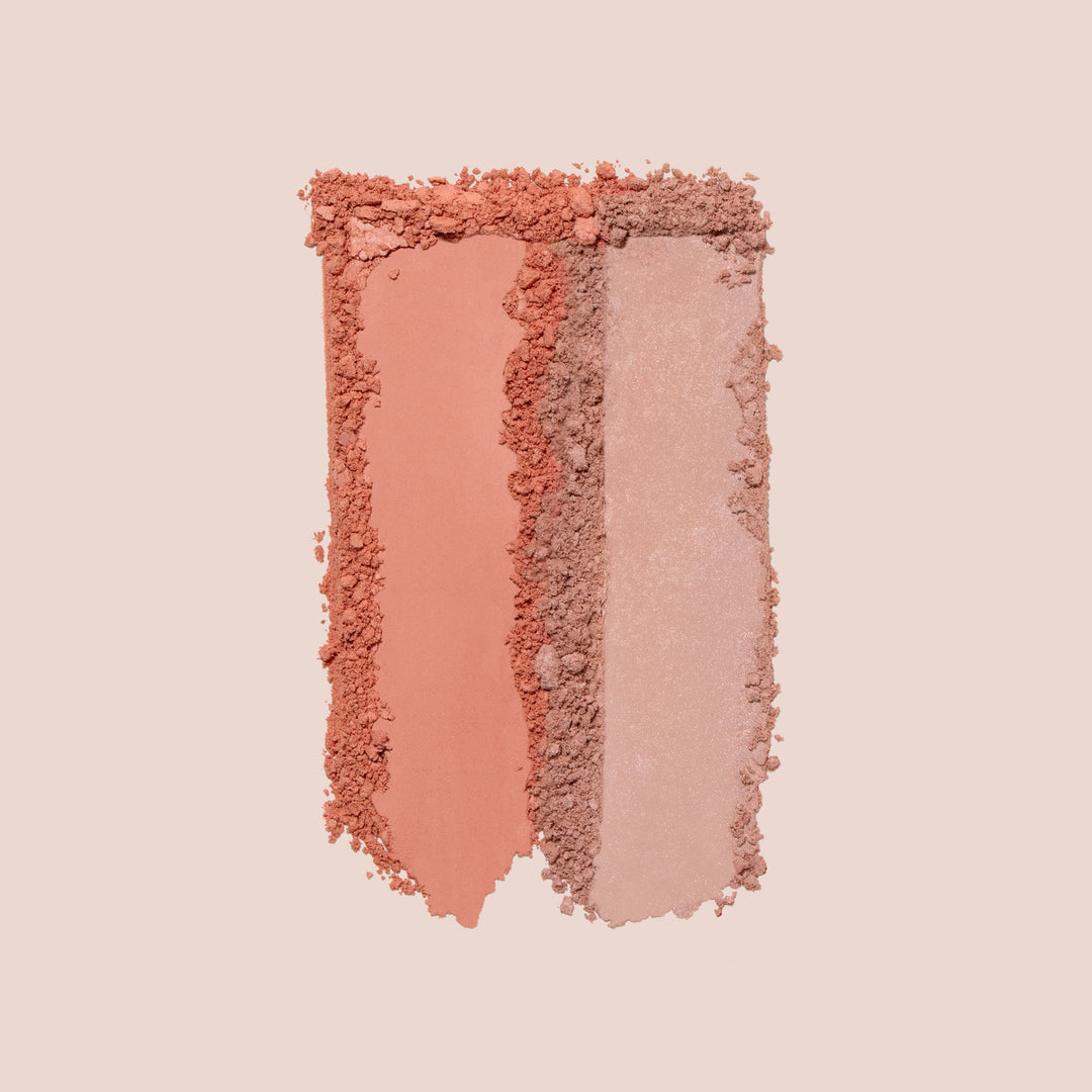 Adore, Two vertical columns of makeup powder swatches, from Jouer Cosmetics' Blush Bouquet, are displayed on a light background. The left swatch, applied with a blush brush, is a warm reddish-brown shade, while the right swatch is a lighter beige shade. Both vegan formula powders have a smooth yet crumbled texture that shows depth and variation.