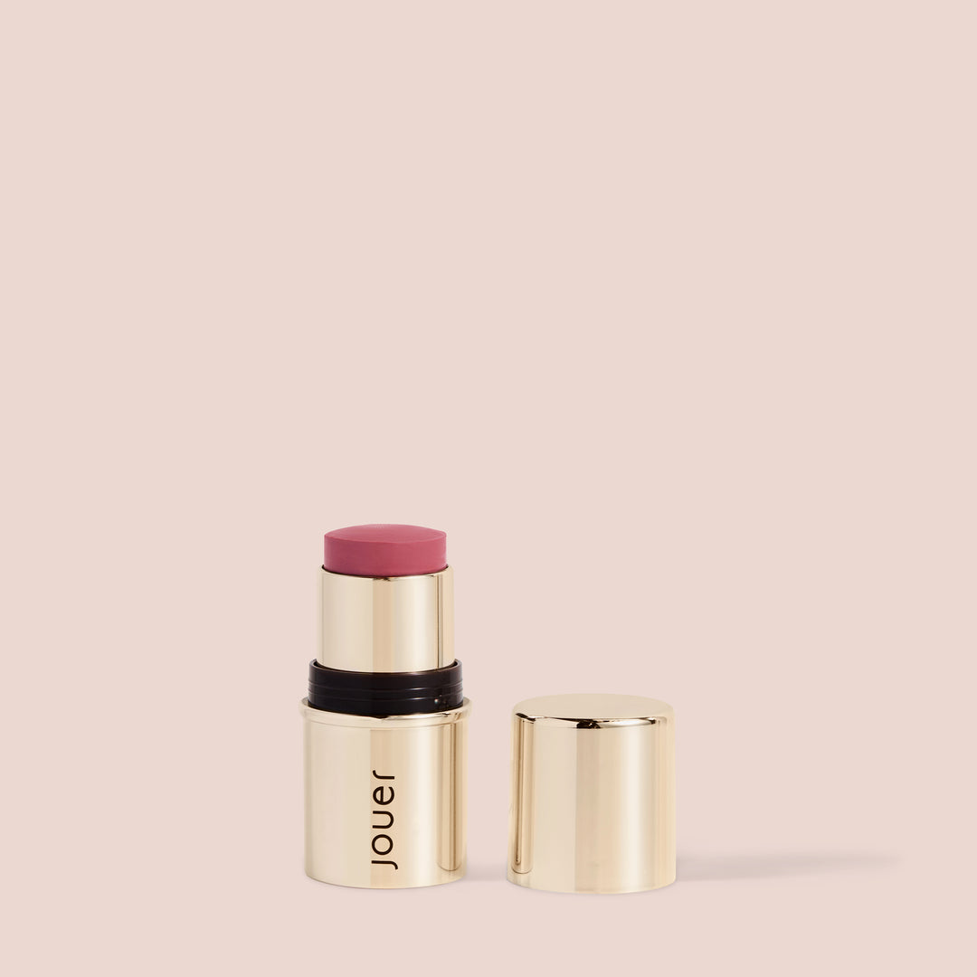 Rose blush lipstick in a sleek gold twist-up tube by Jouer, featuring a soft muted rose shade for cheeks and lips.