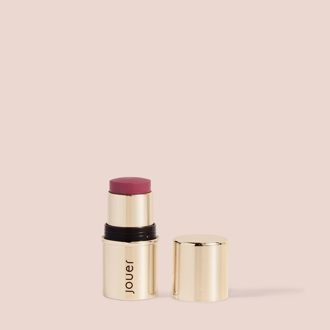 Bright rose lip cheek stick in a luxe gold Jouer tube, delivering vibrant color for both lips and cheeks in one swipe