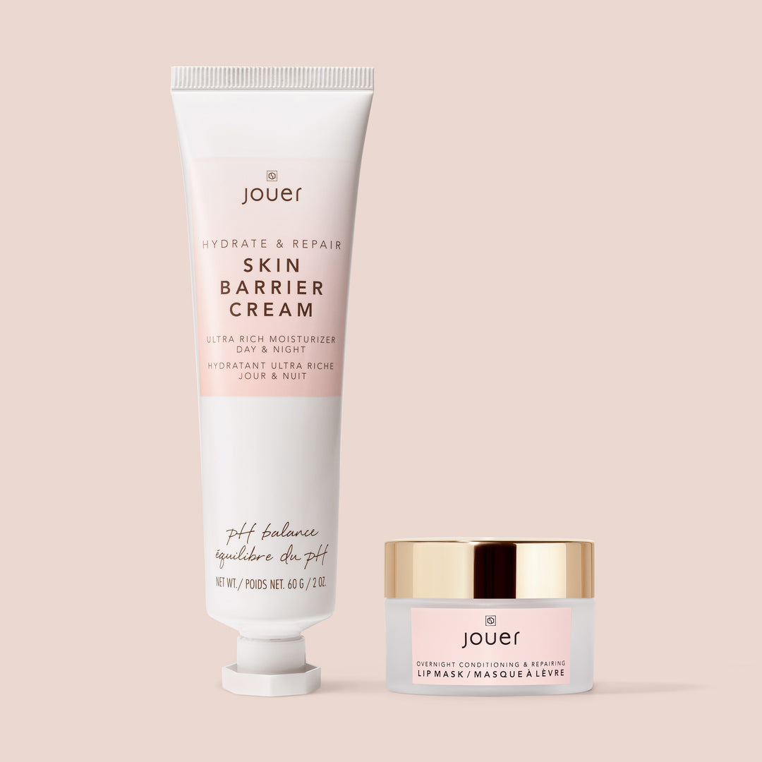 Jouer Hydrate & Repair Skin Barrier Cream and Overnight Lip Mask displayed on a blush pink background, showcasing the minimalist pink-and-gold packaging of the skincare duo.