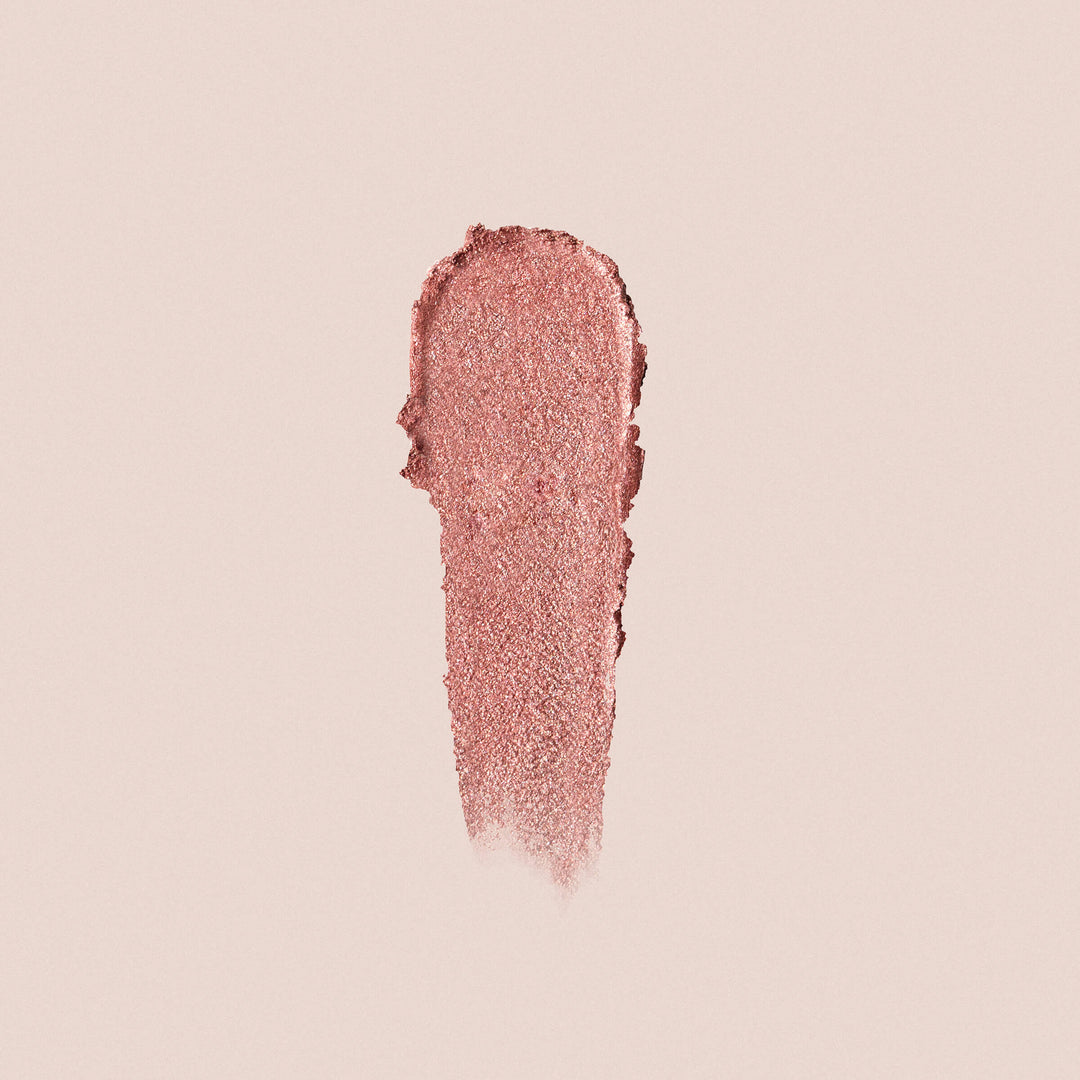Rose gold crème eyeshadow swatch on neutral background showing shimmer finish