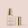 ivory, full size alt:A bottle of Jouer Cosmetics Essential Crème Foundation featuring a pump dispenser and a metallic gold cap placed beside it. The label highlights the inclusion of hyaluronic acid and its matte, oil-free formula, while also proudly stating that it is gluten-free and cruelty-free. The background is a solid light beige color.