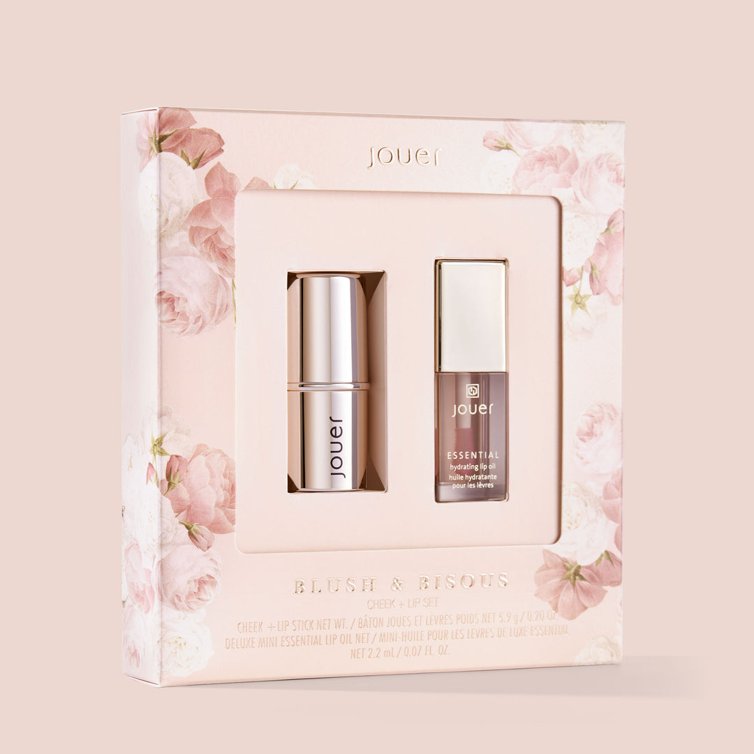 A boxed set with a pink floral design containing a Jouer Blush &amp; Bloom Cheek + Lip Duo Stick and a Jouer Essential Lip Enhancer.