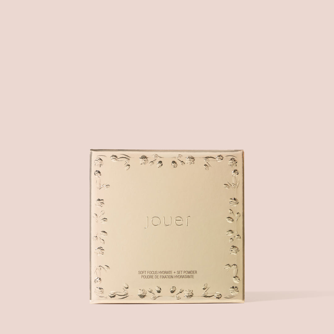 Closed gold soft focus powder compact unit carton box with embossed floral border