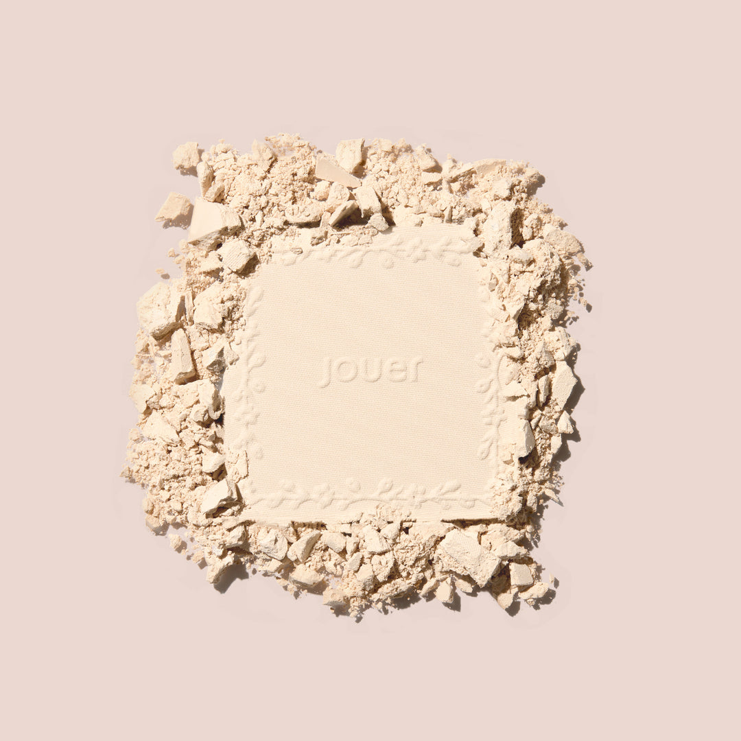 Pressed soft focus powder square with floral embossing surrounded by crushed powder