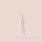 A small rose tube of Rose Lip Enhancer from Jouer Cosmetics on a plain light peach background. The tube stands upright with the cap off, revealing the applicator tip. Gold text on the front reads "Jouer," indicating its Maxi-Lip™ formula enriched with Shea Butter for superior care.