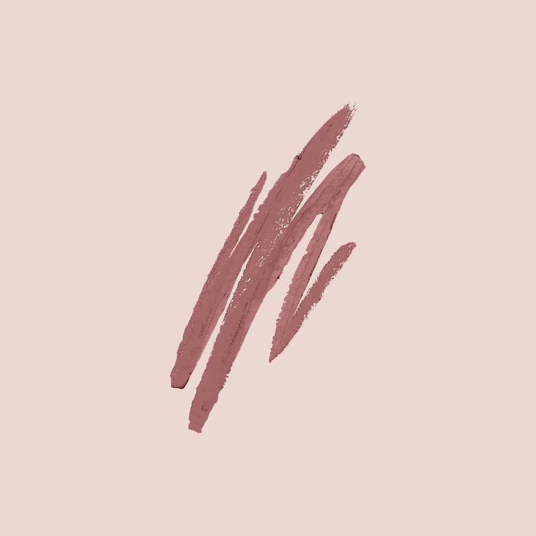 wild rose, A beige background features several streaks of Jouer Cosmetics' Lip Liner in mauve hues, drawn diagonally across the center, creating abstract, uneven lines.