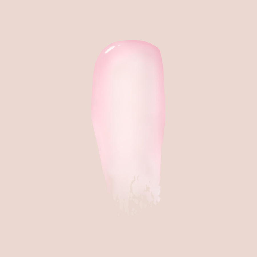 Pink tinted Essential Shine Balm tube with glossy finish on neutral background