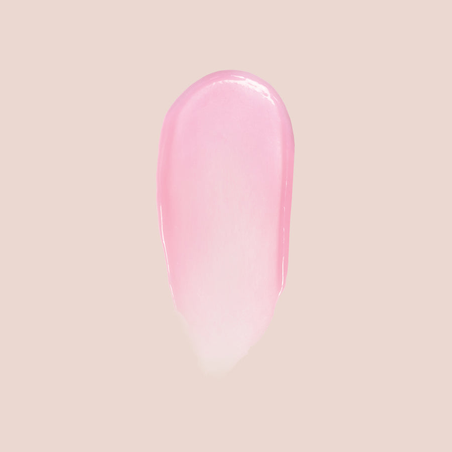 Swatch of a pH-adjusting lip balm showing a glossy, sheer pink tint that adapts to your natural lip color.