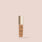 Jouer Essential high coverage creme foundation bottle with gold cap on beige background