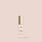Jouer Essential high coverage creme foundation bottle with gold cap on beige background