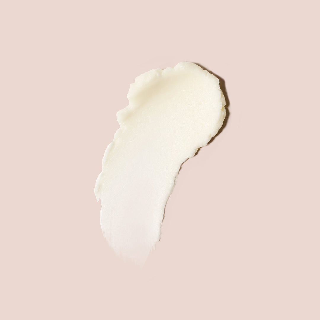 Skin barrier face cream swatch in a creamy, rich texture shown on a soft nude background for moisturizing skincare visuals.