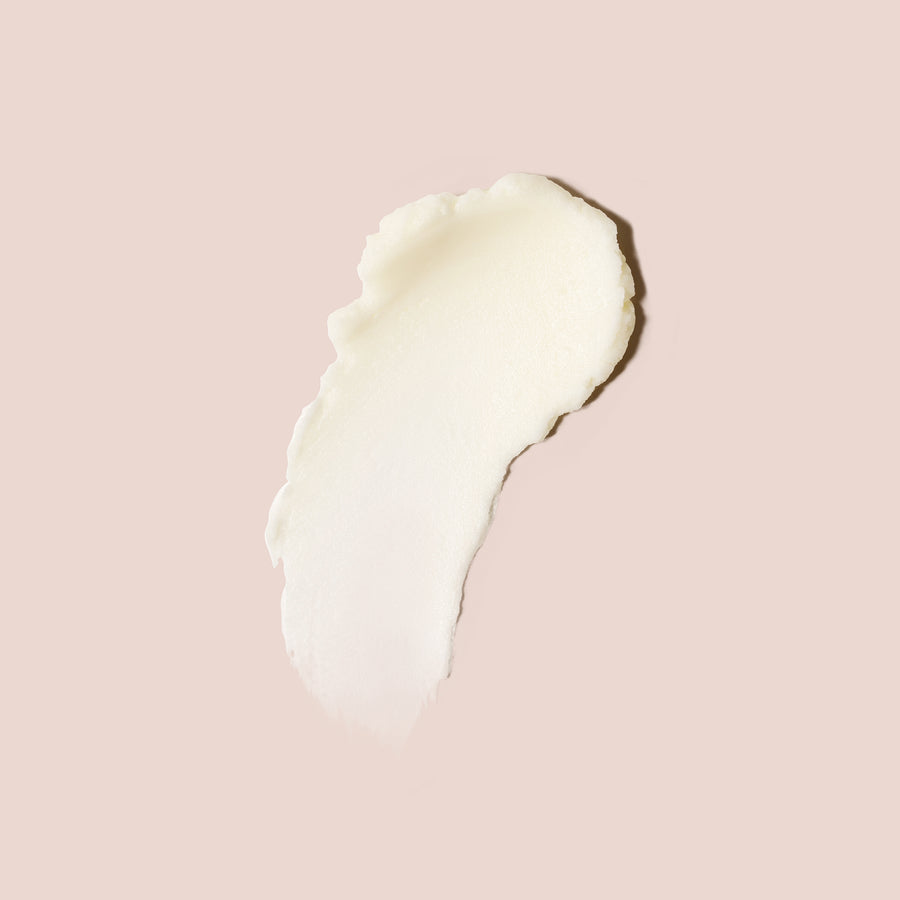 Skin barrier face cream swatch in a creamy, rich texture shown on a soft nude background for moisturizing skincare visuals.