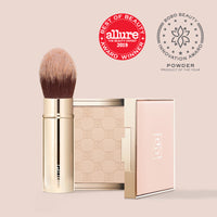 Jouer setting powder compact with retractable brush and pink case, showing award badges