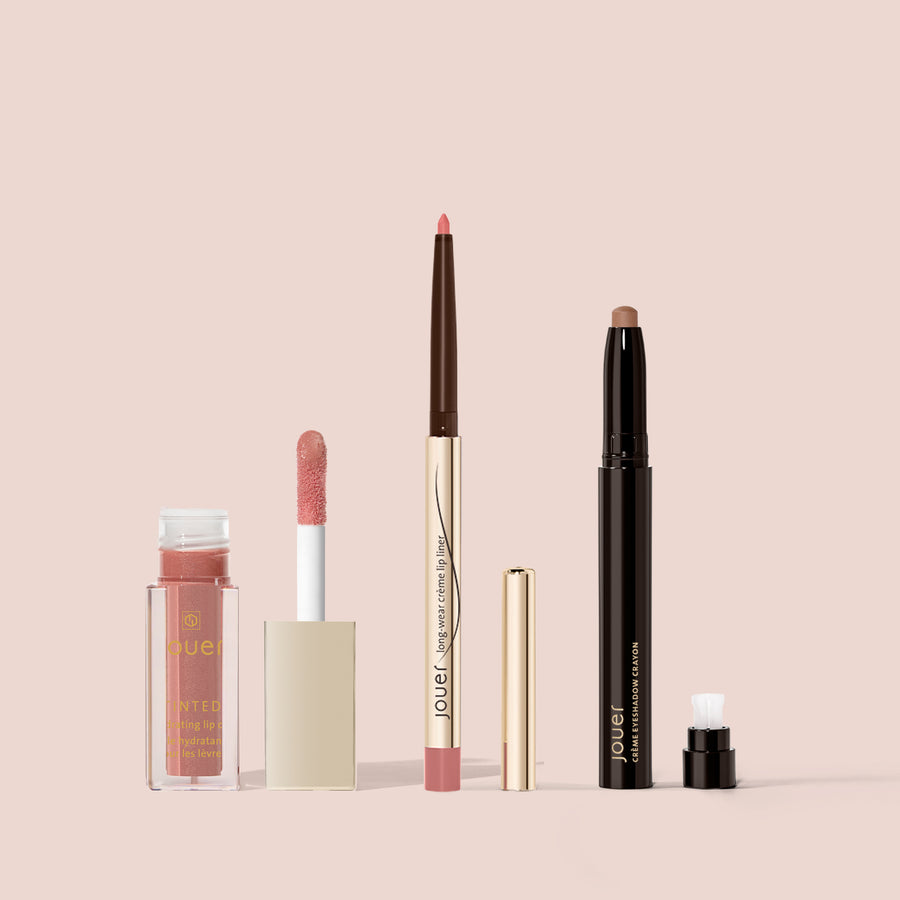 Jouer Any Day Everyday Set featuring a tinted lip oil, lip liner, long-wear crème lip liner, and eyeshadow crayon on a beige background.