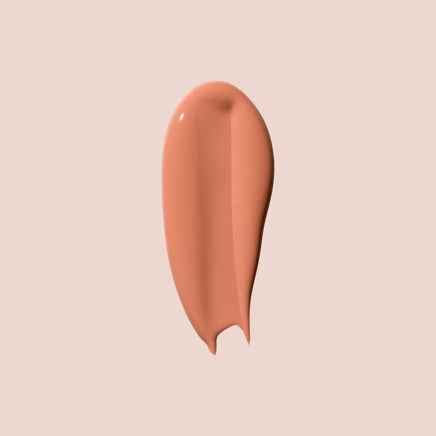 Creamy peach-toned swatch of Jouer Brightening Under-Eye Corrector in Tan Bright