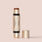 Sungaze, This dual-ended beauty stick from Jouer Cosmetics, named "Bloom, Bronze & Glow," features a bronze shade on one end and a glow highlighter on the other. It is vegan and comes with a gold cap, resting elegantly on a light surface.