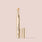 honey, An image of a gold-colored tube of Jouer Cosmetics' Essential Concealer Pen with its cap removed, revealing the vegan concealer stick inside. The background is a solid, light beige color. The pen is elegantly designed with sleek packaging and perfect for covering dark circles.
