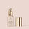 alabaster, full size alt: The Essential Crème Foundation by Jouer Cosmetics comes in a light beige bottle with a gold pump dispenser and a matching gold cap placed beside it. The bottle features text stating that the foundation contains hyaluronic acid, offers a matte, oil-free finish, and is cruelty-free, making it an ethical choice in beauty.
