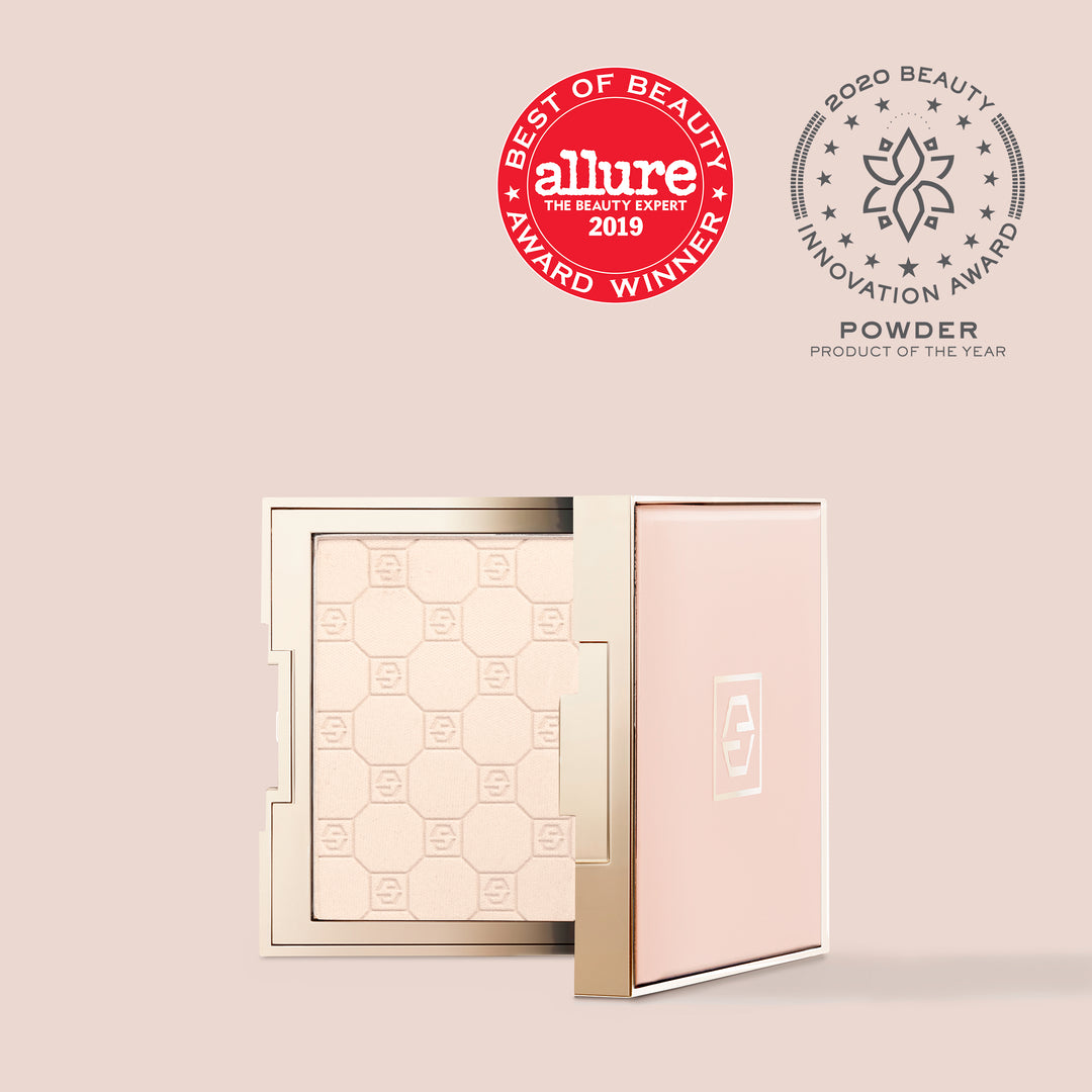 Très Translucent, An image of the translucent 'Soft Focus' compact powder cosmetic by Jouer Cosmetics, featuring a pink lid and opened to reveal the vegan, paraben-free powder inside. The compact is adorned with two award logos: "Allure Best of Beauty Award Winner 2019" and "2020 Beauty Innovation Award Powder Product of the Year.