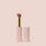 Jouer Balm Bouche pink lip balm with gold accent and matching cap against soft pink background