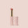 Sororite, A pink lipstick tube with a golden base and the cap removed, revealing a soft warm nude pink lipstick. The brand name "Jouer Cosmetics" is printed in gold on the body of the tube, which identifies this luxurious product as "Balm Bouche." The cap is placed next to the tube, all set against a light beige background. This exquisite product is also vegan and paraben-free.